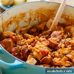 30 Creative Ways to Reinvent Leftover Turkey 26 An image of a pot of chicken jambalaya with a wooden spoon in it.