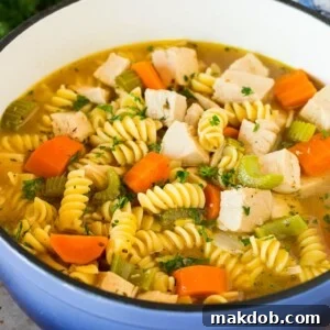 30 Creative Ways to Reinvent Leftover Turkey 27 A pot of turkey noodle soup with vegetables, garnished with parsley.