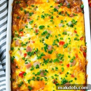 A savory Hash Brown Egg Casserole featuring ham, various vegetables, and melted cheese, baked to golden perfection.