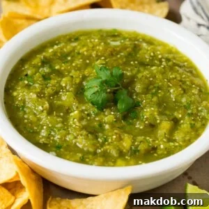 A bowl of salsa verde served with tortilla chips.