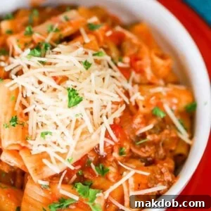 A picture of a slow cooker pasta made with Italian sausage and rigatoni.