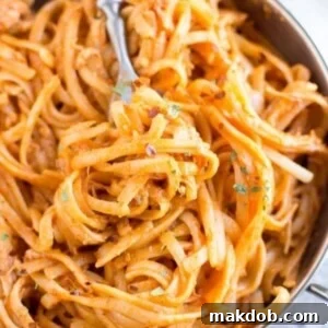 An image of a pot with slow cooker firecracker chicken pasta.