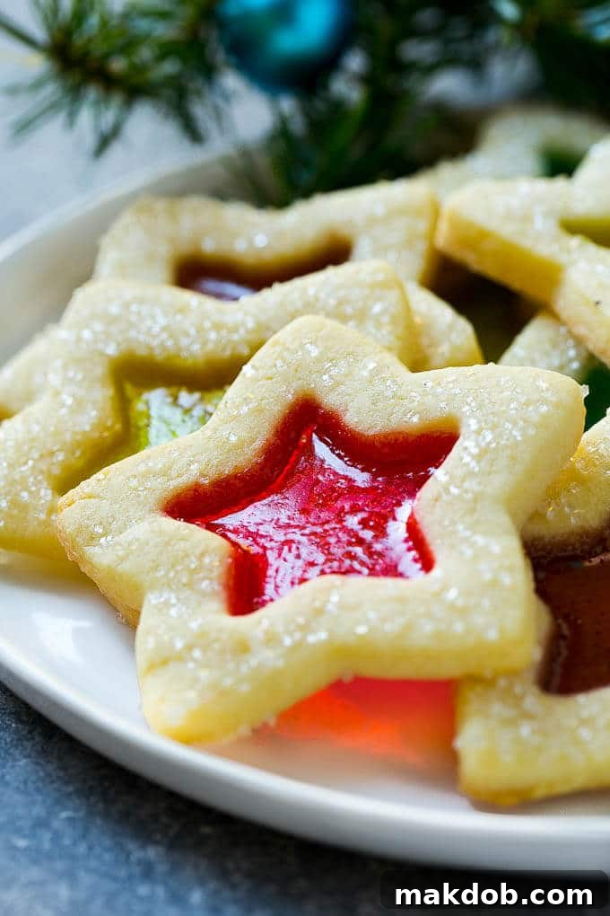 A star shaped cookie with a clear candy center, resting on a serving plate.