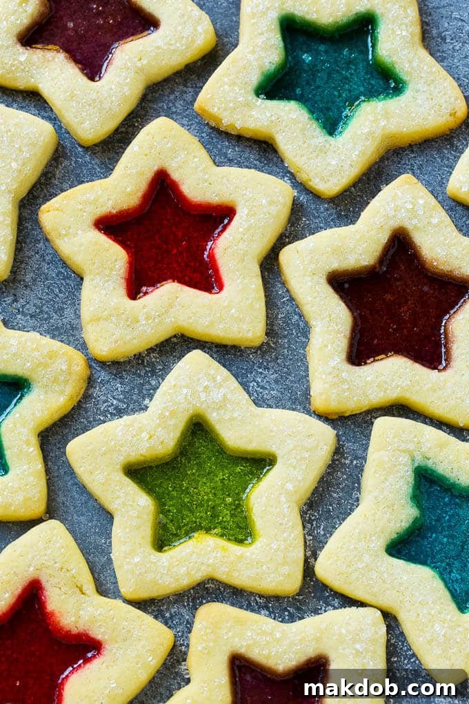 A collection of stained glass window cookies in various colors and shapes.