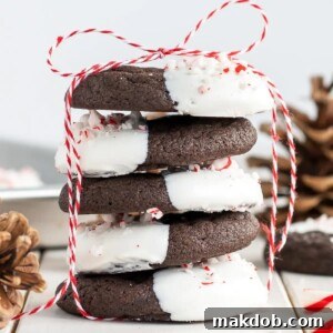 A stack of delightful Dark Chocolate Candy Cane Cookies, showcasing their rich chocolate base and festive peppermint topping, ready to be enjoyed.