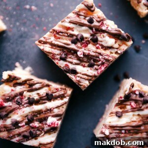 Three delightful Peppermint Rice Krispie Treats, layered with festive peppermint bark, promising a chewy, crispy, and minty holiday snack.