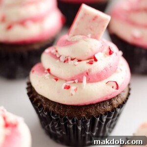 Decadent Peppermint Chocolate Candy Cane Cupcakes, featuring rich chocolate cupcakes adorned with a vibrant candy cane swirl of buttercream frosting.