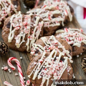 These festive peppermint bark cookies feature decadent double chocolate cookies topped with creamy white chocolate and crunchy crushed candy canes, perfect for holiday baking parties.