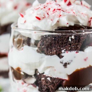 An image of a layered candy cane brownie trifle served elegantly in a glass.