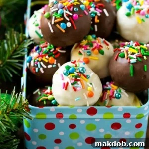 An array of dark and white chocolate Oreo balls, beautifully arranged in a gift tin, awaiting their recipients.