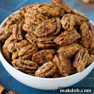 A charming bowl overflowing with homemade candied pecans, ready to be enjoyed as a snack or a delightful gift.
