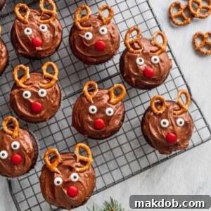 Christmas reindeer cupcakes with chocolate fudge frosting and pretzel antlers.