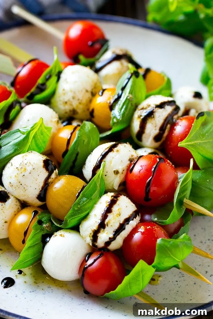 Caprese Skewers | Caprese Kabobs | Caprese Appetizer #tomato #mozzarella #basil #caprese #appetizer #dinneratthezoo A beautifully arranged plate of Caprese skewers, showcasing individual mozzarella, tomato, and basil portions, perfectly ready for a party.