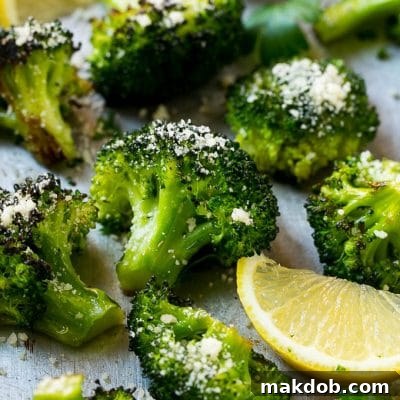 This parmesan roasted broccoli is seasoned with olive oil, parmesan and herbs. Put it in a hot oven and cook until tender and browned for the best broccoli you'll ever have!