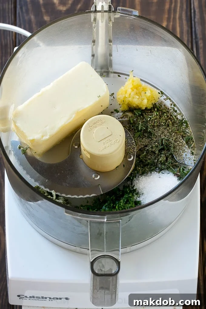 A bowl of freshly made compound butter, rich with minced garlic and finely chopped fresh herbs like sage, rosemary, and thyme, ready to be applied to a turkey.