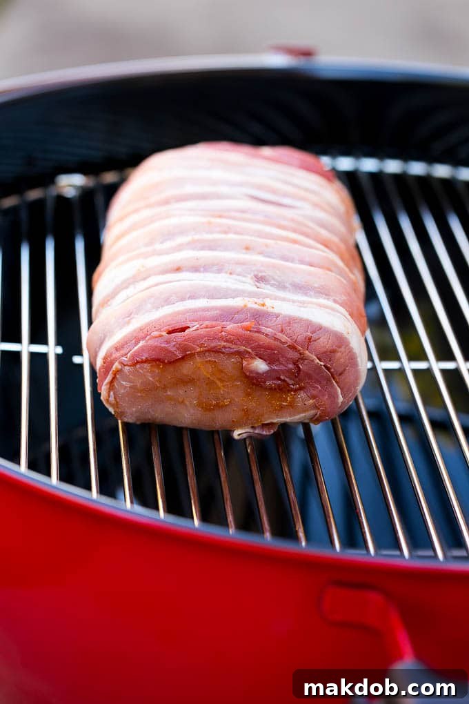 Bacon Wrapped Pork Loin Recipe | Bacon Wrapped Pork Roast | Grilled Pork Loin | Grilled Pork Recipe #bacon #pork #dinner #grilling #dinneratthezoo A bacon wrapped pork loin cooking on a Weber kettle grill using indirect heat.