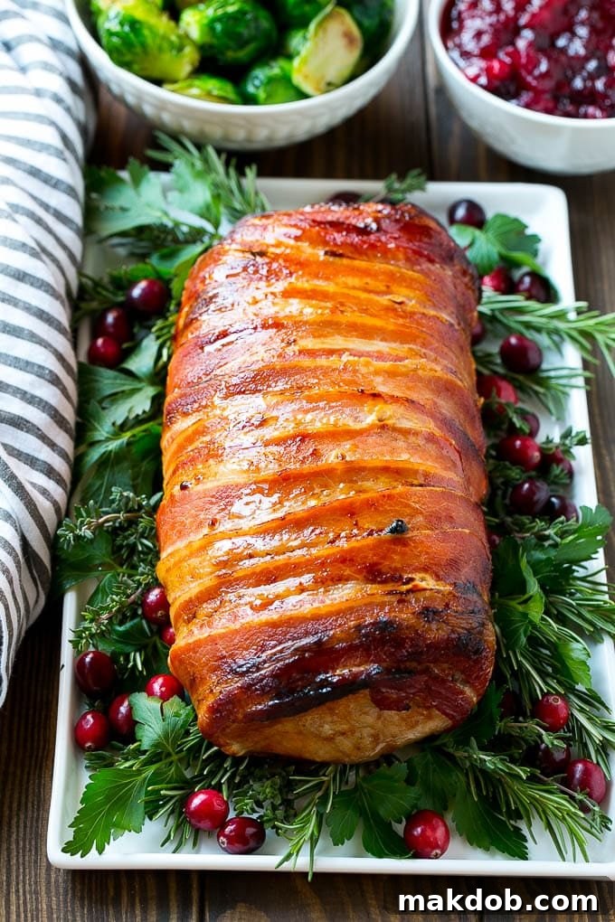 Bacon Wrapped Pork Loin Recipe | Bacon Wrapped Pork Roast | Grilled Pork Loin | Grilled Pork Recipe #bacon #pork #dinner #grilling #dinneratthezoo A perfectly grilled bacon wrapped pork roast, sliced and ready to serve as an easy and elegant holiday entree.
