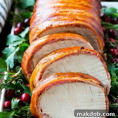 This bacon wrapped pork loin roast is brushed with a sweet and savory glaze, then covered in bacon and grilled to perfection.