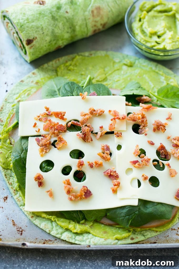 A spinach tortilla layered with turkey, spinach, cheese and bacon.