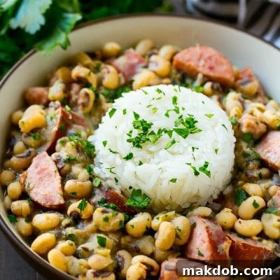 These slow cooker black eyed peas are loaded with ham, sausage and veggies. The perfect crock pot meal to get your new year off to the right start!