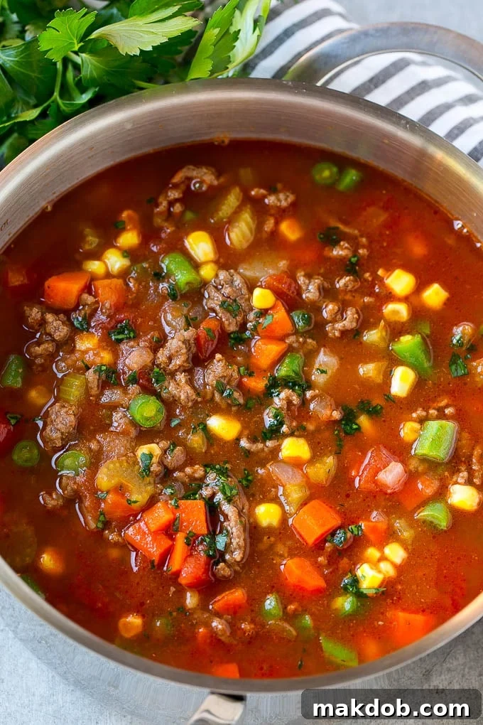 Loaded Burger Soup 6 A large pot of perfectly cooked hamburger soup, richly colored and full of ground beef, vegetables, and potatoes, ready to be served.