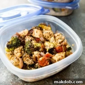 A clear container showcasing a delicious Italian-style chicken and vegetable meal.