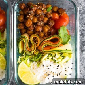 A picture of Korean style chickpeas with vibrant veggies and rice, perfect for a bento box.