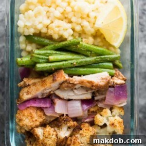 A picture of couscous with flavorful chicken and colorful veggies, making a Moroccan-inspired meal.