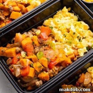 An inviting image of a wholesome breakfast meal prep featuring fluffy eggs, sweet potato, and a savory sausage hash.