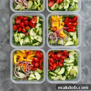 Several bowls of fresh salads, prepared for everyday meal prepping.