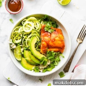 A perfectly portioned bowl of BBQ salmon with tender zucchini and creamy avocado slices.