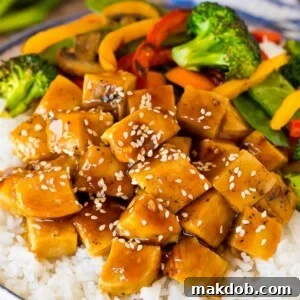 Delicious teriyaki chicken bowl with colorful vegetables served over fluffy rice.