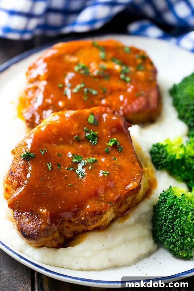 Honey garlic pork chops served over mashed potatoes with a side of broccoli.