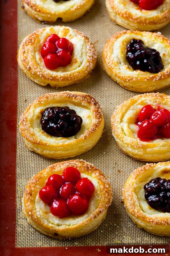 Luscious Fruit Cream Cheese Danish 6 Freshly baked cream cheese danishes are garnished with generous dollops of colorful cherry and blueberry pie fillings in their centers.