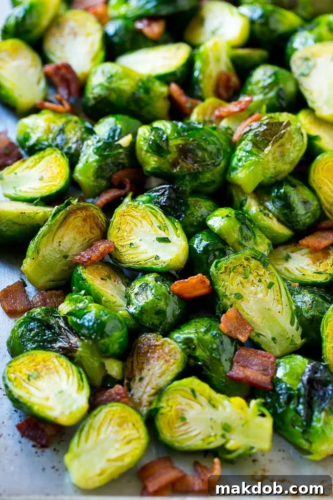 Oven Roasted Brussels Sprouts with Bacon A sheet pan loaded with oven-roasted Brussels sprouts and crispy bacon.