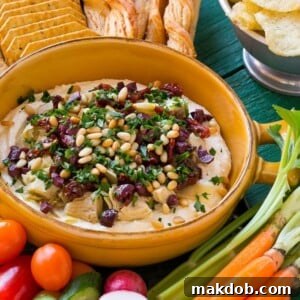 This mediterranean layered dip starts with a base of whipped feta cheese and is topped with artichokes, olives, sun dried tomatoes and pine nuts. Ready in about 10 minutes, it's the perfect party appetizer!