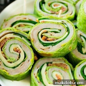 These turkey roll ups are pinwheel sandwiches filled with cheese, avocado, bacon, turkey and spinach.