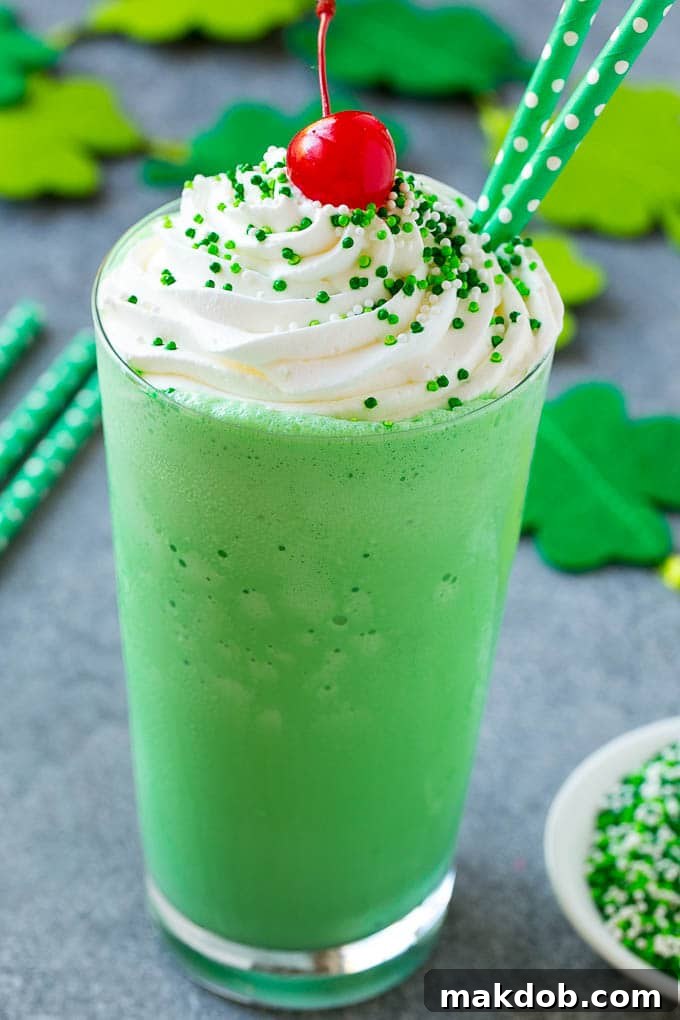 Whip Up Your Own Shamrock Shake 6 A glass of shamrock shake topped with whipped cream, sprinkles and a cherry.