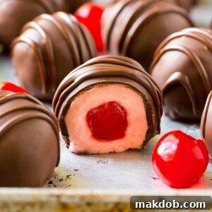 Chocolate covered cherries dipped in dark chocolate with a decorative drizzle.