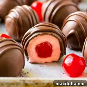 Chocolate covered cherries dipped in dark chocolate with a decorative drizzle.