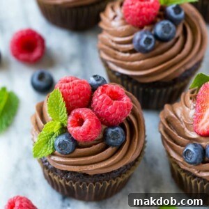 This recipe for chocolate hazelnut cupcakes is chocolate cupcakes filled with milk chocolate hazelnut spread, then finished off with chocolate hazelnut frosting and fresh berries. The perfect treat for a special occasion! #chocmeister #chocolatehazelnut #ad