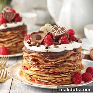 An image of a chocolate raspberry mini crepe cake on a plate.
