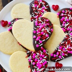 Heart cookies dipped in dark chocolate and decorated with Valentine's Day sprinkles.