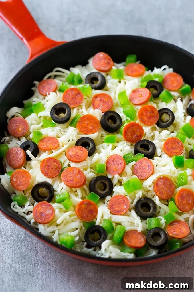 Pizza Dip with Pepperoni and Veggies Shredded mozzarella cheese topped with mini pepperoni, sliced olives, and diced green peppers for a supreme pizza dip.
