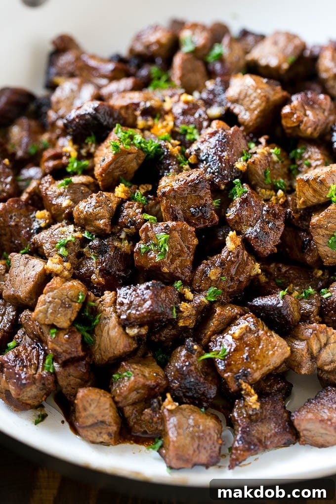 Bites of sirloin steak in a garlic sauce, ready to be served.