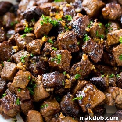 Bites of sirloin steak in a garlic sauce.