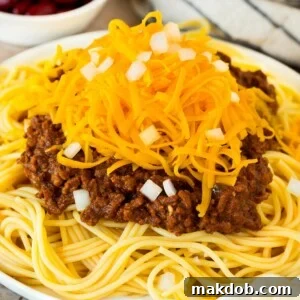 Cincinnati chili served over spaghetti with a generous topping of cheese and onions.