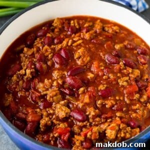 A pot of savory turkey chili served with cornbread.