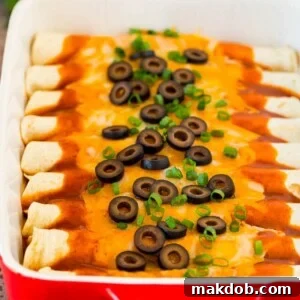 A dish of cheese enchiladas topped with black olives and green onions.