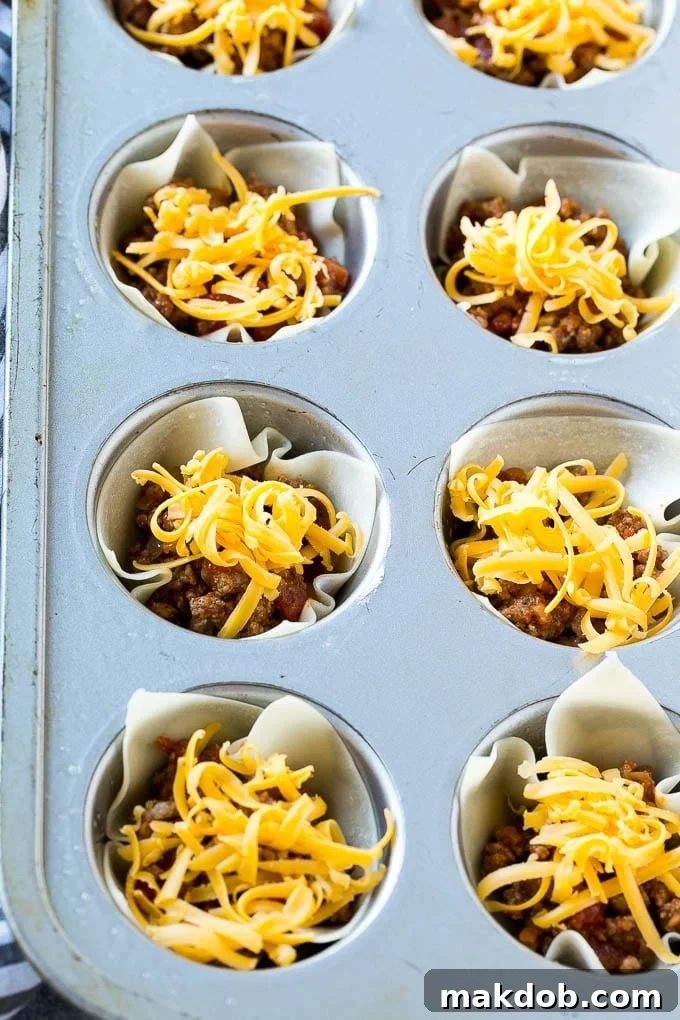 Taco Cups Recipe | Wonton Taco Cups | Taco Cupcakes | Mexican Appetizer #taco #hamburger #appetizer #dinneratthezoo #beef Layers of meat and shredded cheese are combined with wontons then baked.